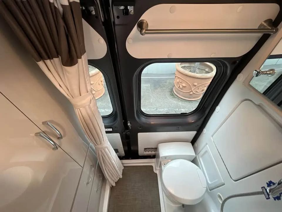 and HVAC controls for comfort.|RV rental interior: View from living area to cockpit with dashboard