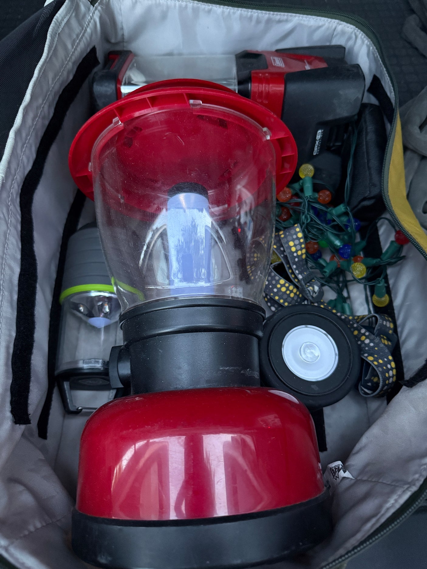 RV rental gear: Essential outdoor lighting, including two lanterns, string lights, and a headlamp, neatly packed for adventure.