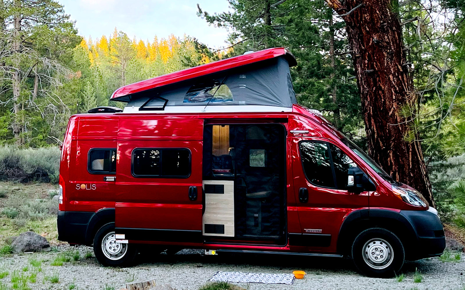 ideal for nature travel.|A red Winnebago Solis camper van