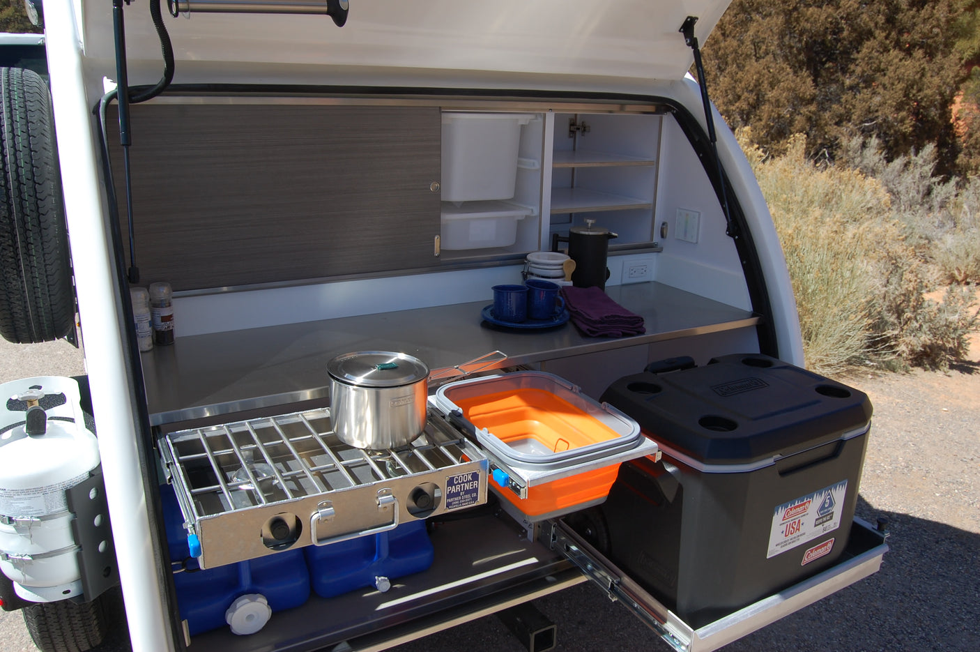 This RV rental's pull-out outdoor kitchen offers a stove, cooler, and smart storage for convenient camping meals.
