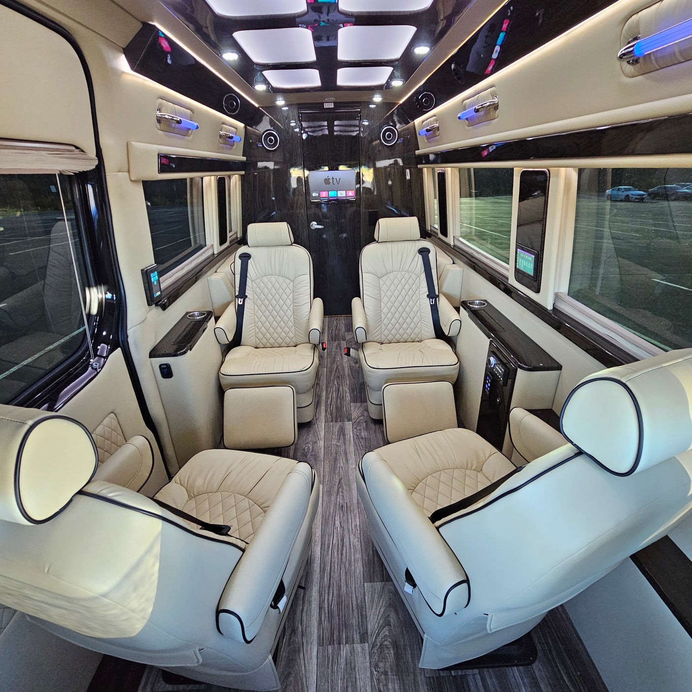 Experience premium travel with this RV rental's lavish interior: cream leather captain's chairs, wood flooring, and an Apple TV system.