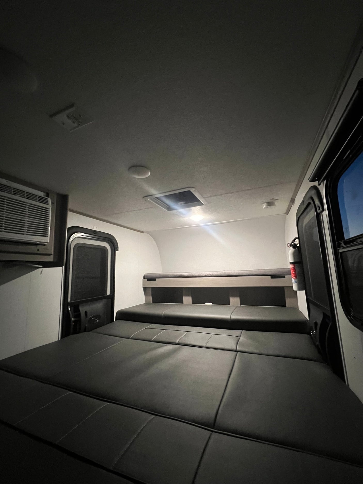 ready for your rv rental.|Inside an RV rental: a cozy sleeping area with convertible seating