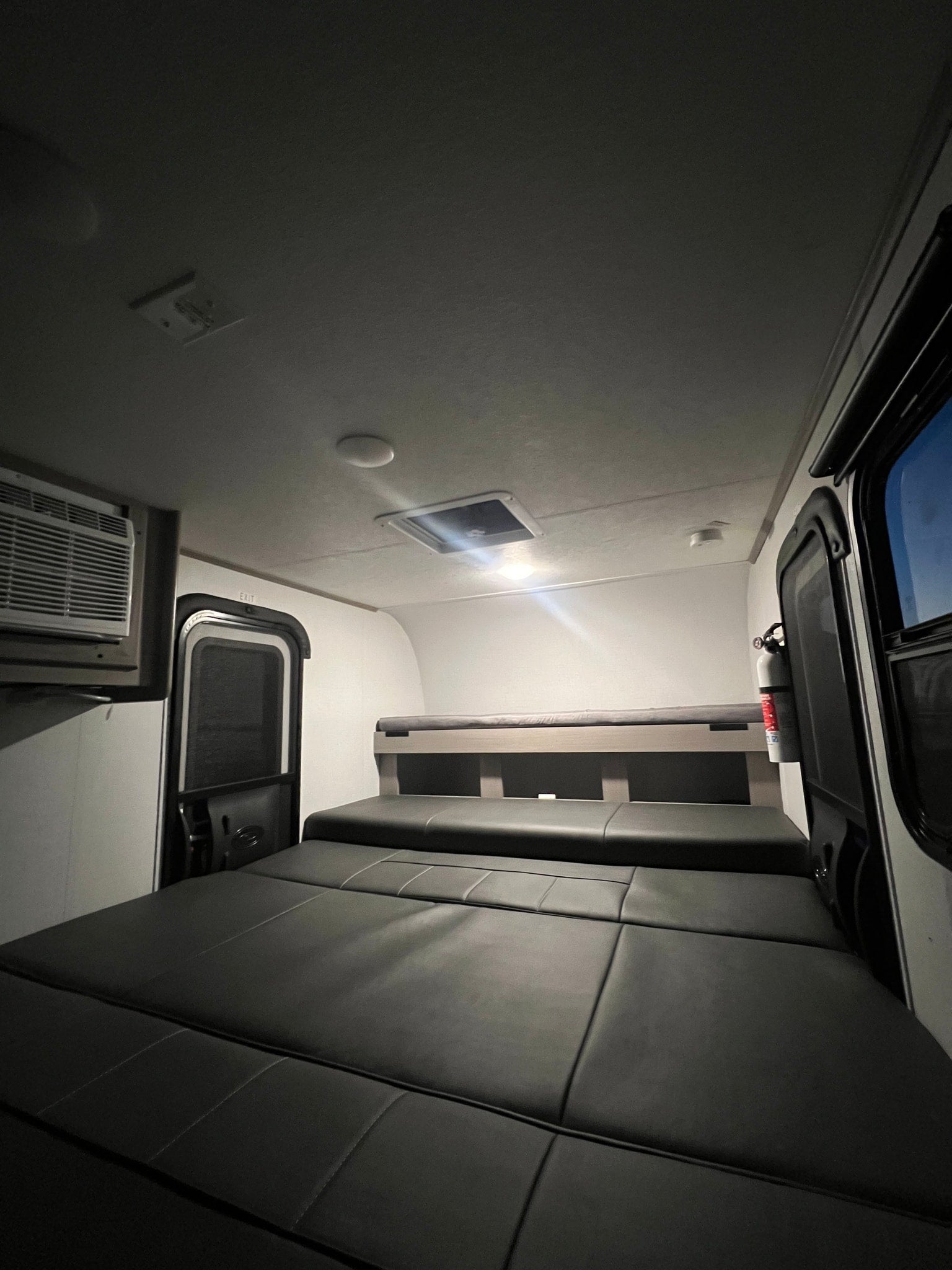ready for your rv rental.|Inside an RV rental: a cozy sleeping area with convertible seating