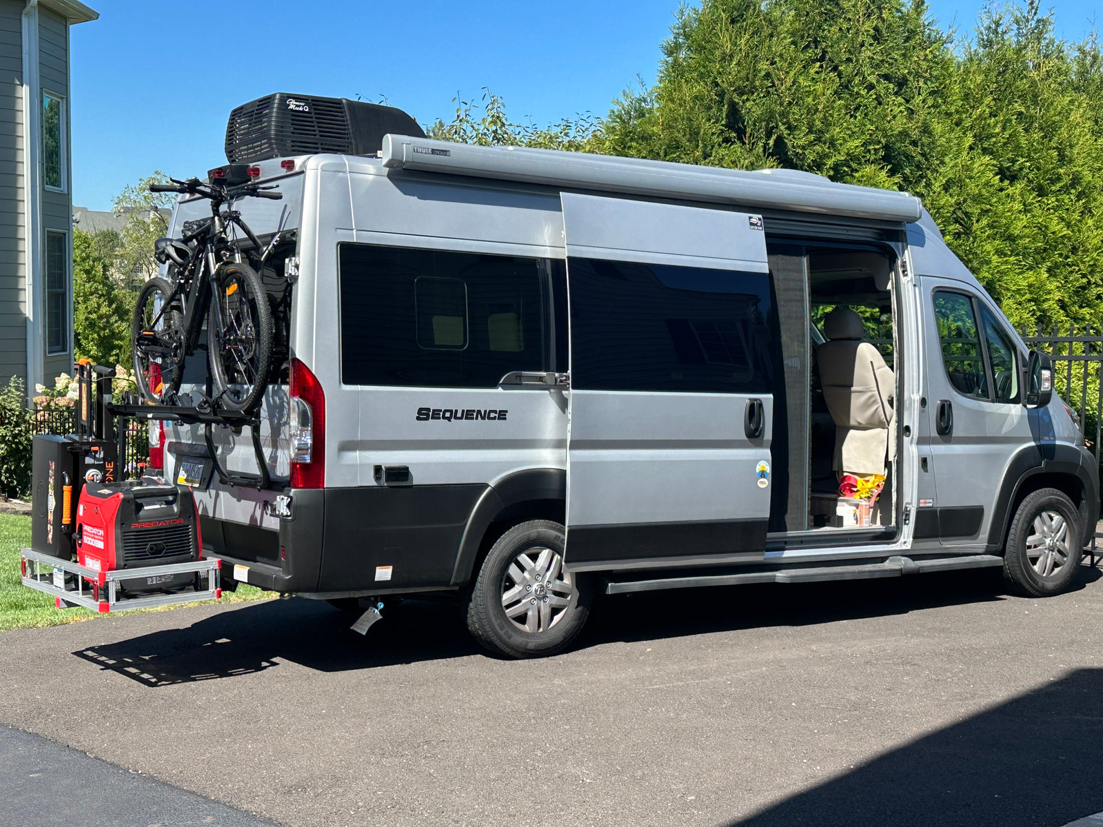 Silver Sequence rv rental van with bikes, generator, and awning. Ready for your next outdoor adventure!