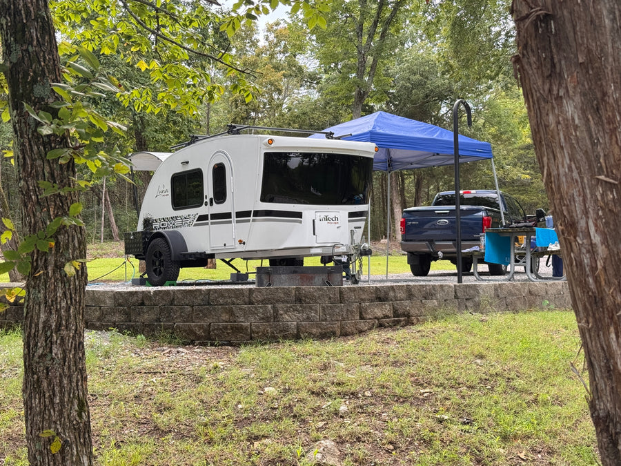 RV rental campsite with white travel trailer
