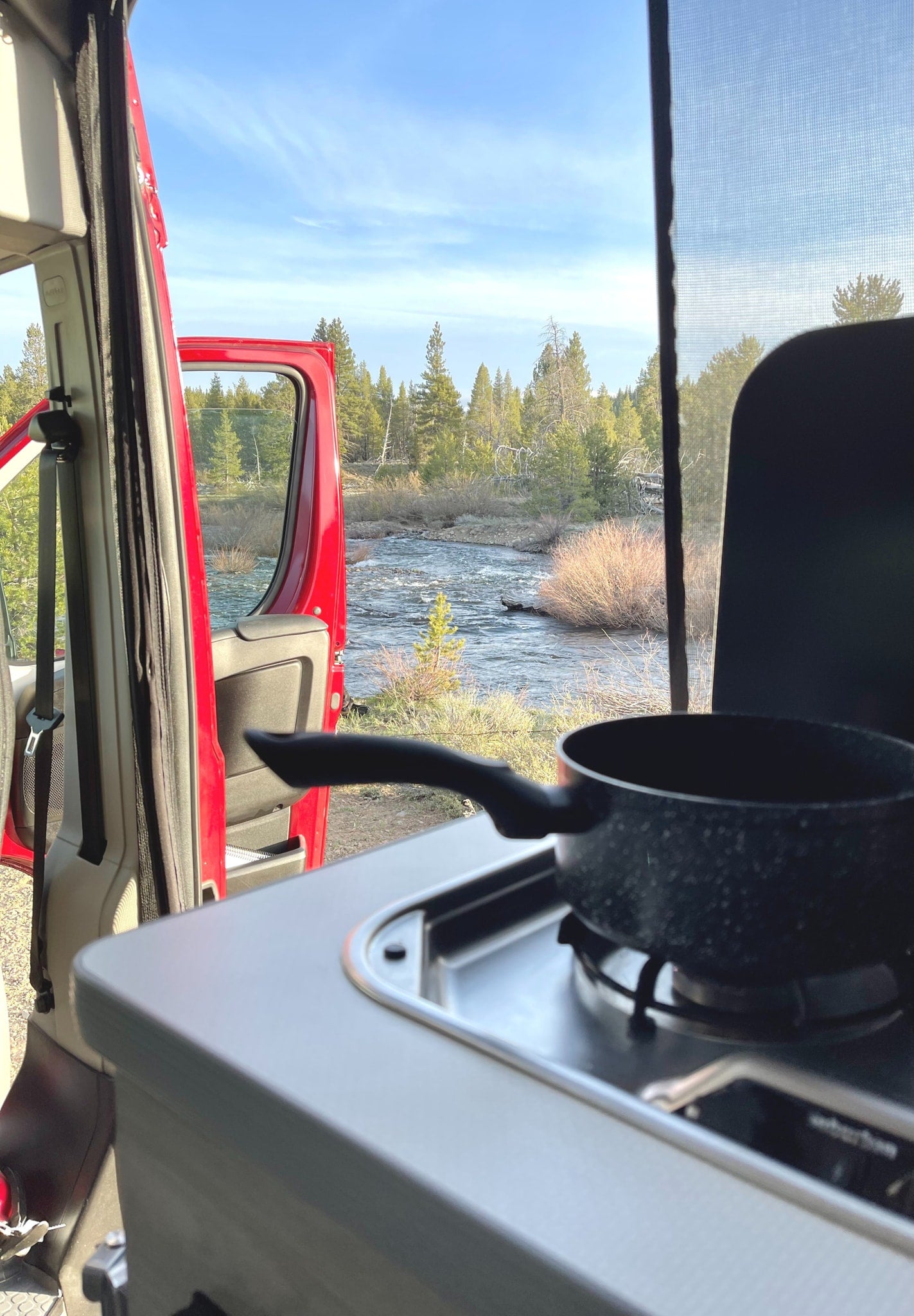 and wood paneling. Ready for adventure.|RV rental interior with cozy blue bedding