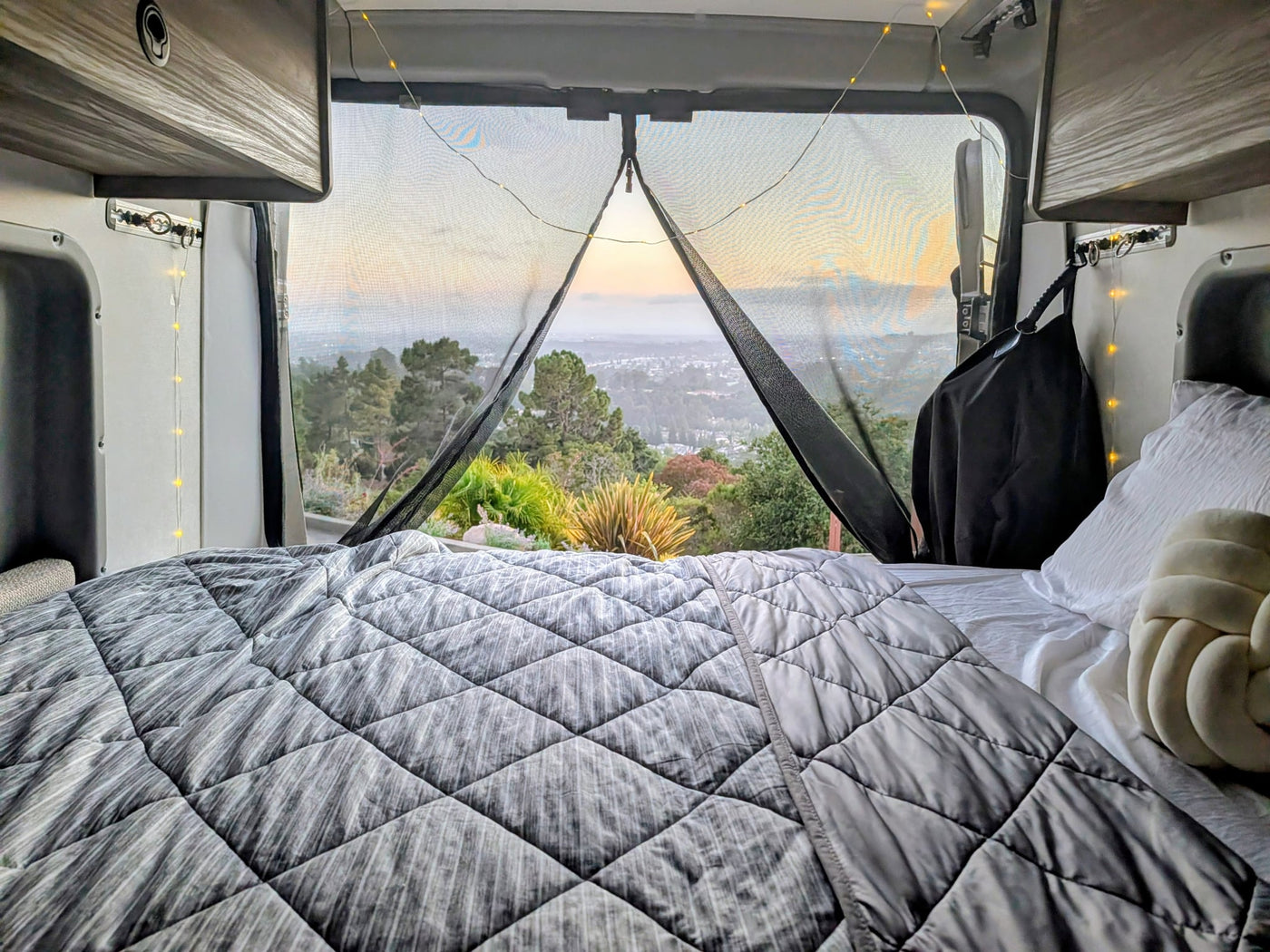with a wooded road ahead.|Cozy RV rental interior featuring comfortable seating — photo 9
