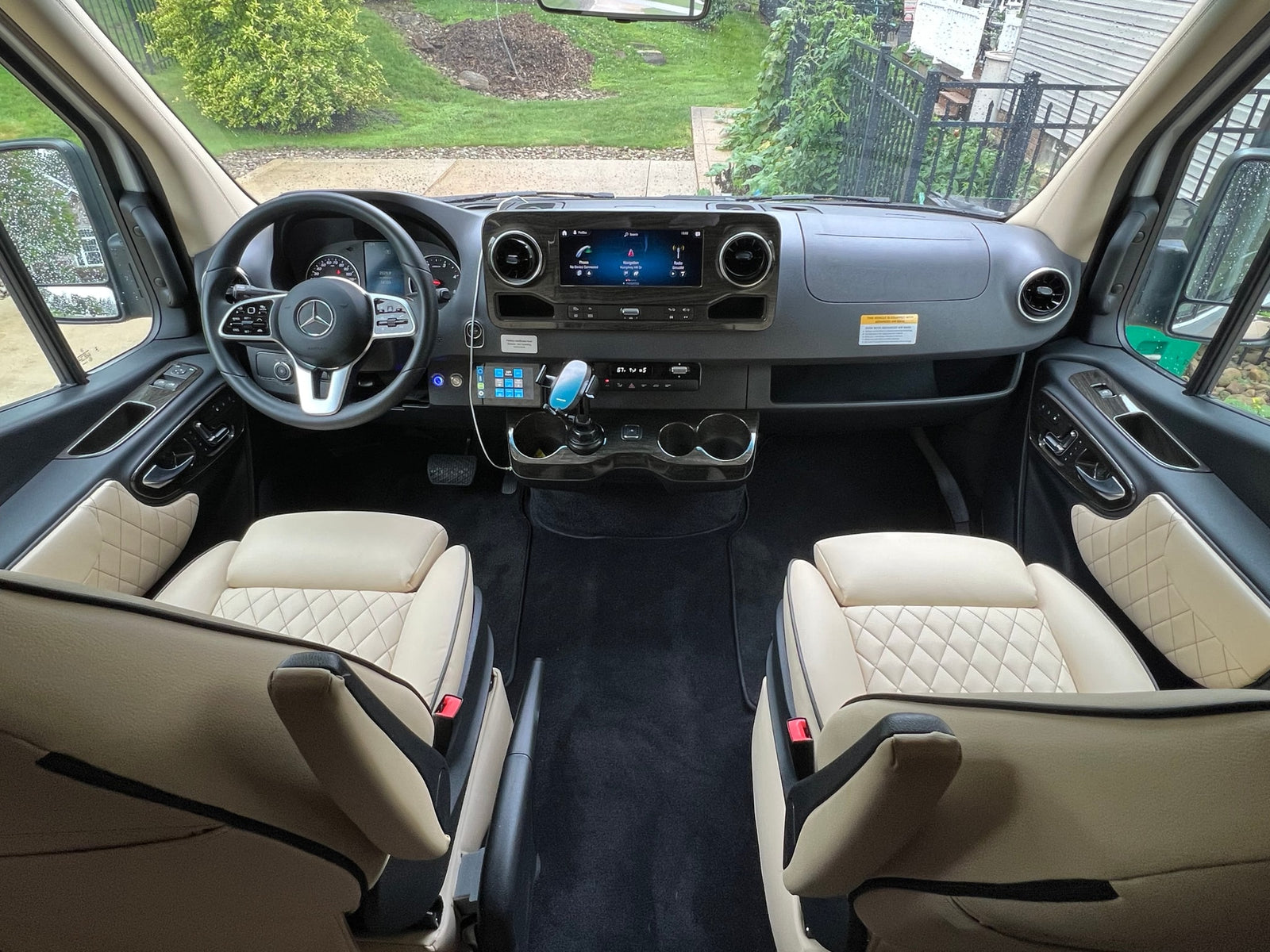 Spacious Mercedes-Benz **RV rental** interior with cream quilted seats and a modern cockpit dashboard, ready for your adventure.
