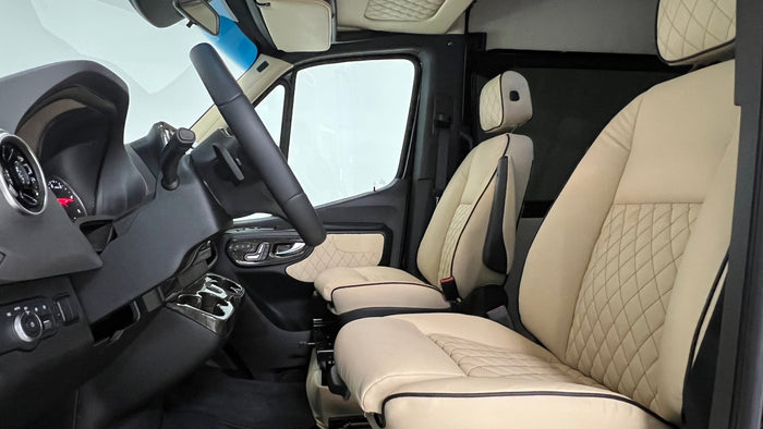 Step into luxury with our RV rental! This premium cockpit features quilted beige leather seats, modern controls, and ample space.