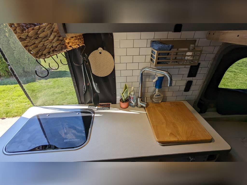 designed for efficient use of space.|Cozy elevated bed in a pop-top RV rental's sleeping area