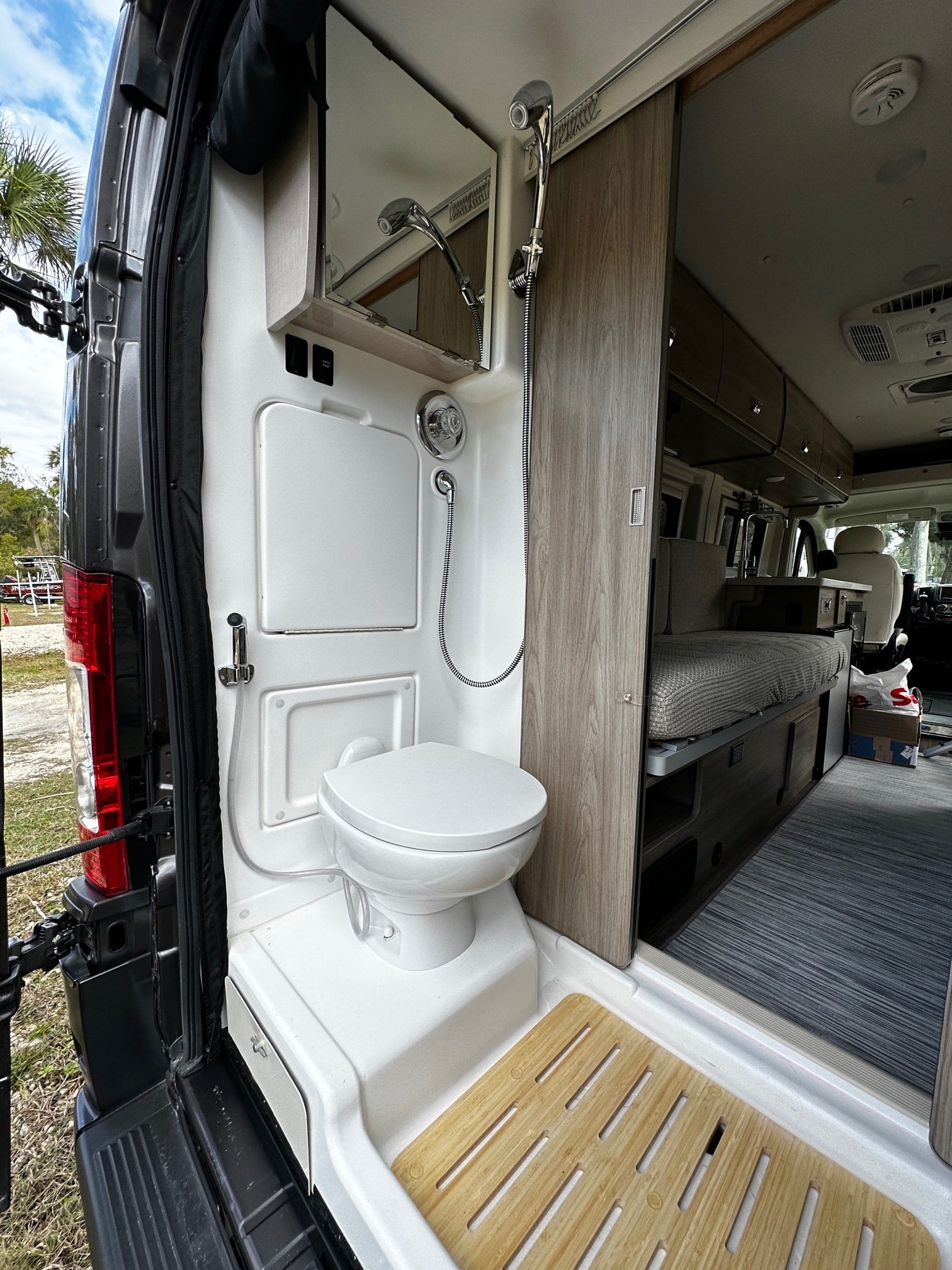 This RV rental's rear interior boasts a functional wet bath with toilet & shower, and a clean living area. Ready for adventure.