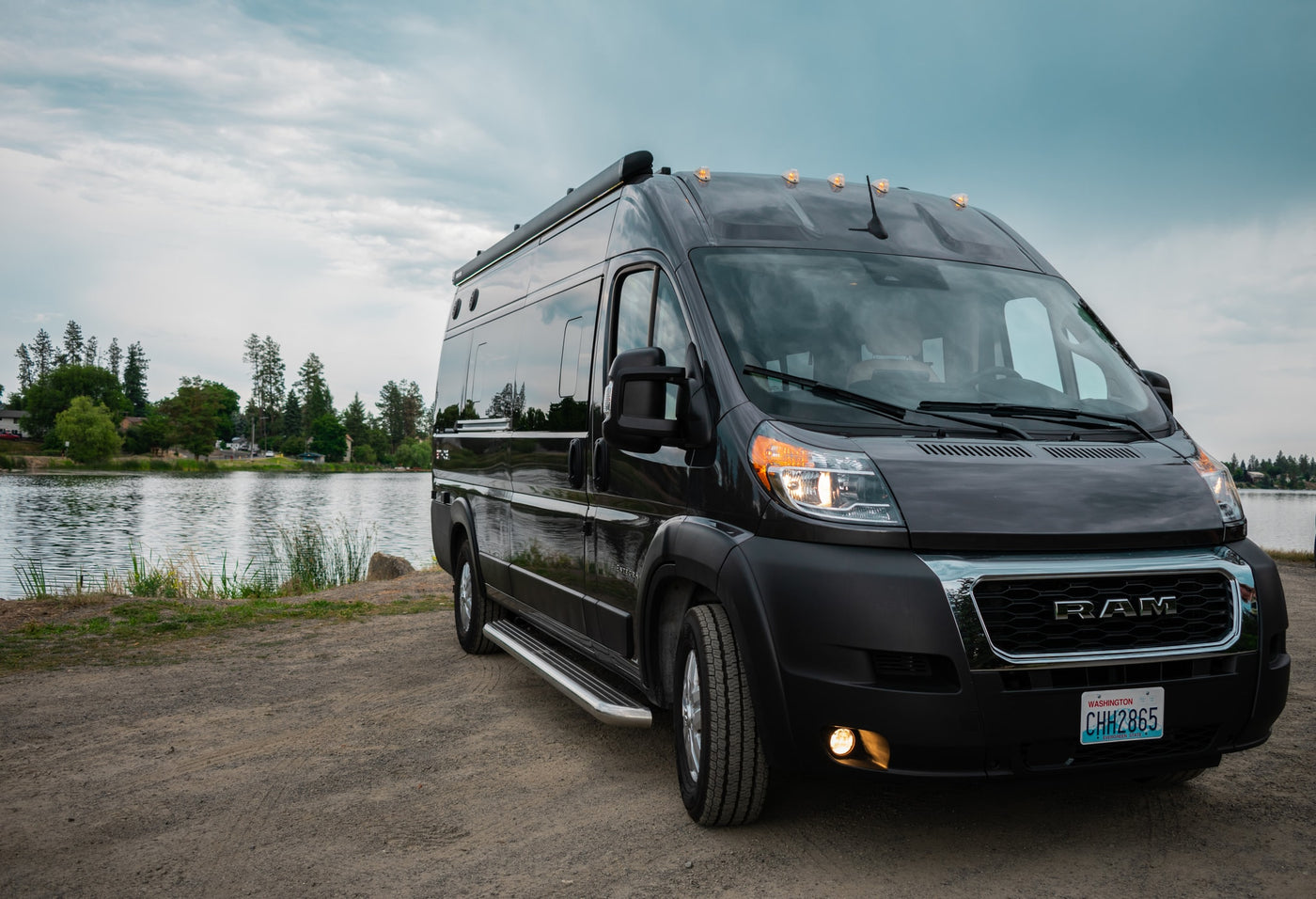 and two chairs.|Compact RV rental kitchen: speckled counter with induction cooktop — photo 9