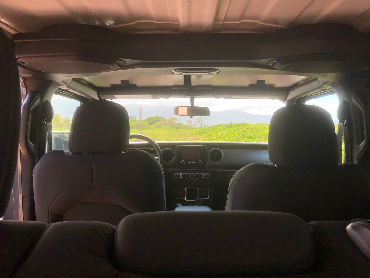 View from a car's rear seat, showing the dashboard and a vibrant green landscape. Perfect setting for an RV rental adventure! — photo 8