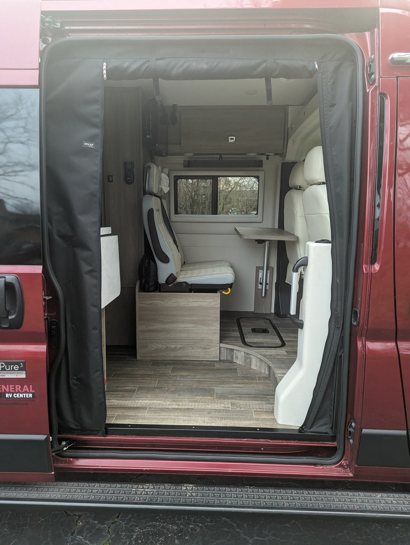 equipped for adventure with a ladder & bike rack. Ideal for an RV rental.|Red van's roof with a Coleman-Mach AC