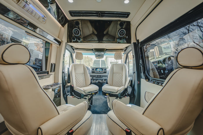 large windows & TV for luxury travel.|Black luxury Mercedes-Benz Sprinter van RV rental