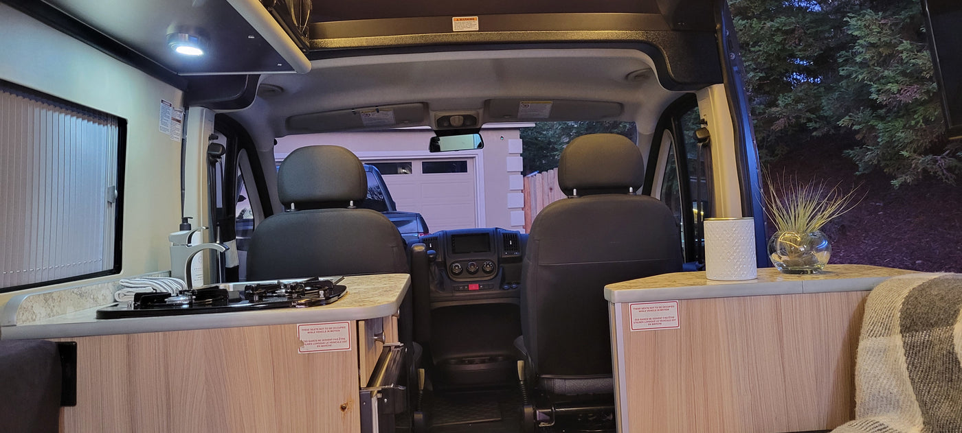 This rv rental interior offers a clear view of the compact kitchen on the left and the front driving cockpit. — photo 4