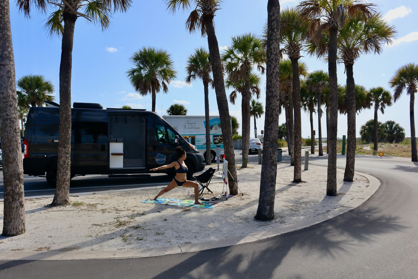 next to white cabinets.|Cozy RV rental interior: A modern camper van with dinette