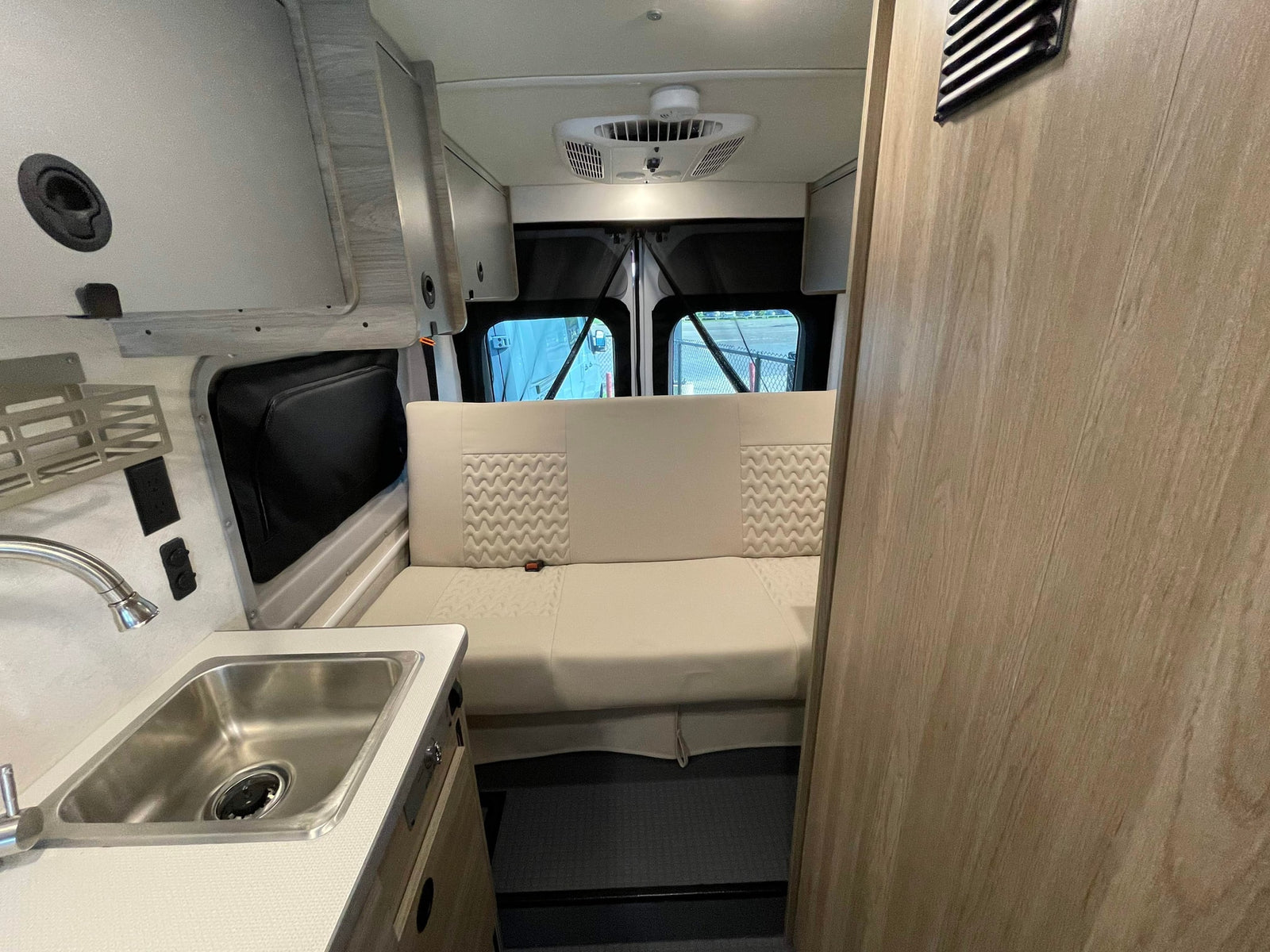 and a Winnebago control panel with solar.|Explore this Winnebago RV rental interior: featuring a kitchenette