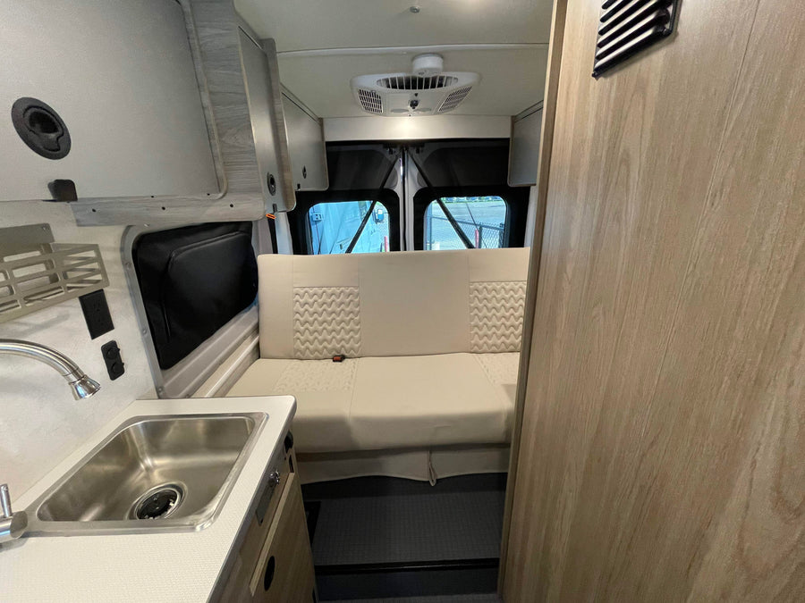 and a Winnebago control panel with solar.|Explore this Winnebago RV rental interior: featuring a kitchenette