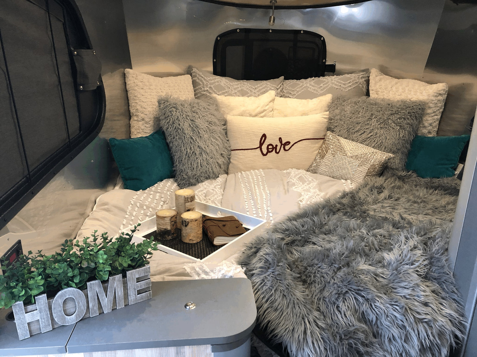 calm river reflecting green mountains under blue sky.|||||||Enjoy the scenic red rock view from your RV rental! This cozy kitchen features a sink