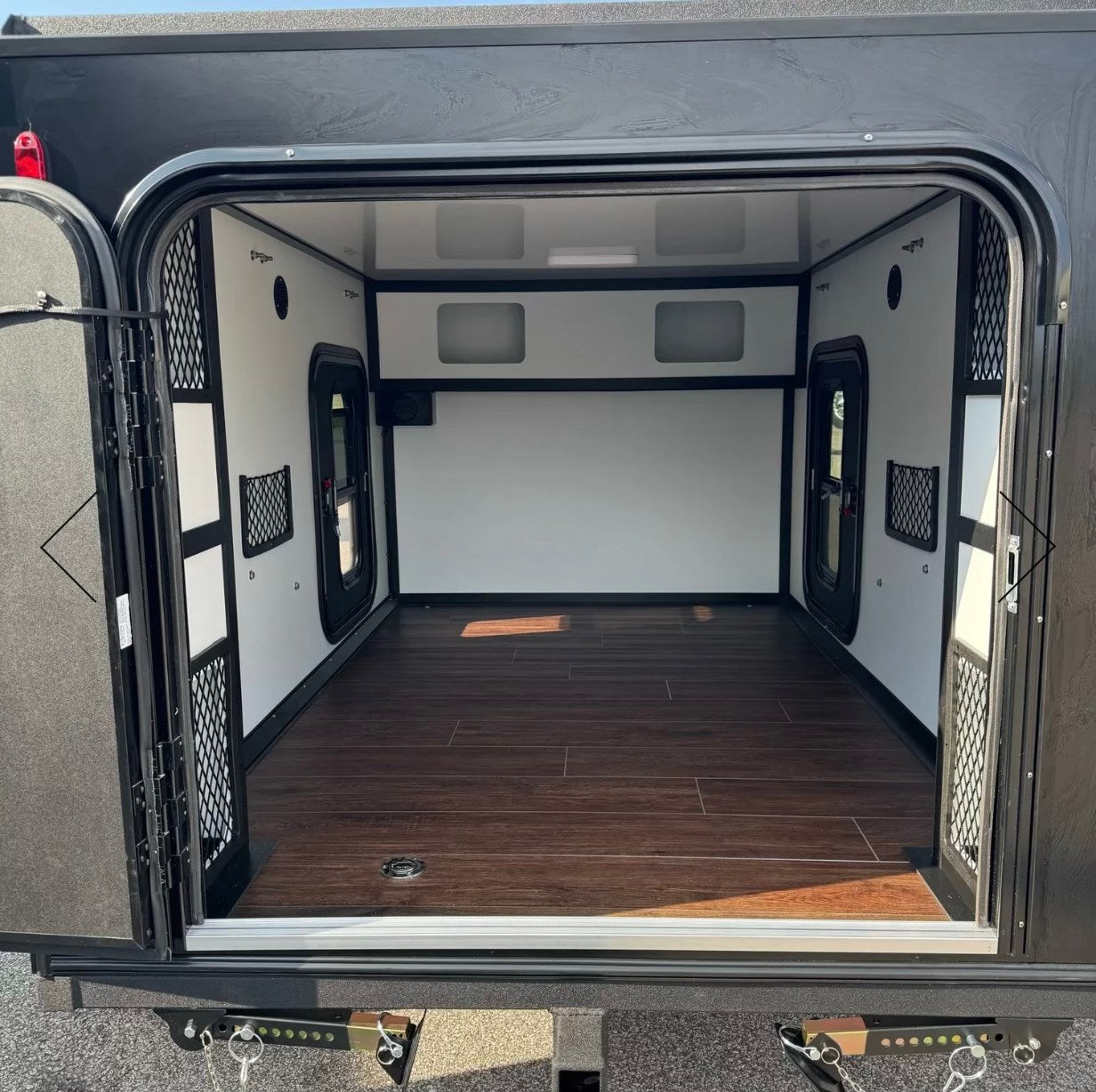 perfect for a relaxing outdoor setup among the trees.|Cozy RV rental interior featuring a bed with botanical decor