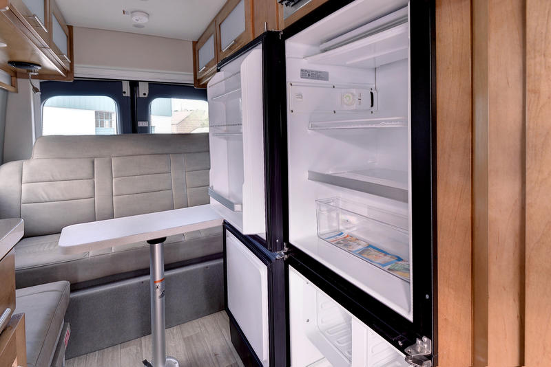 & felt-lined storage.|Explore this RV rental's efficient interior: compact kitchen