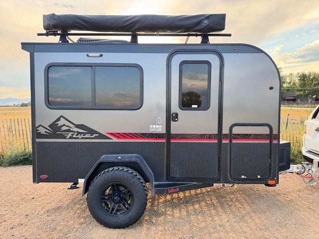 Explore off-grid with this rugged InTech Flyer travel trailer, ideal for an RV rental. Features an awning and all-terrain tires.