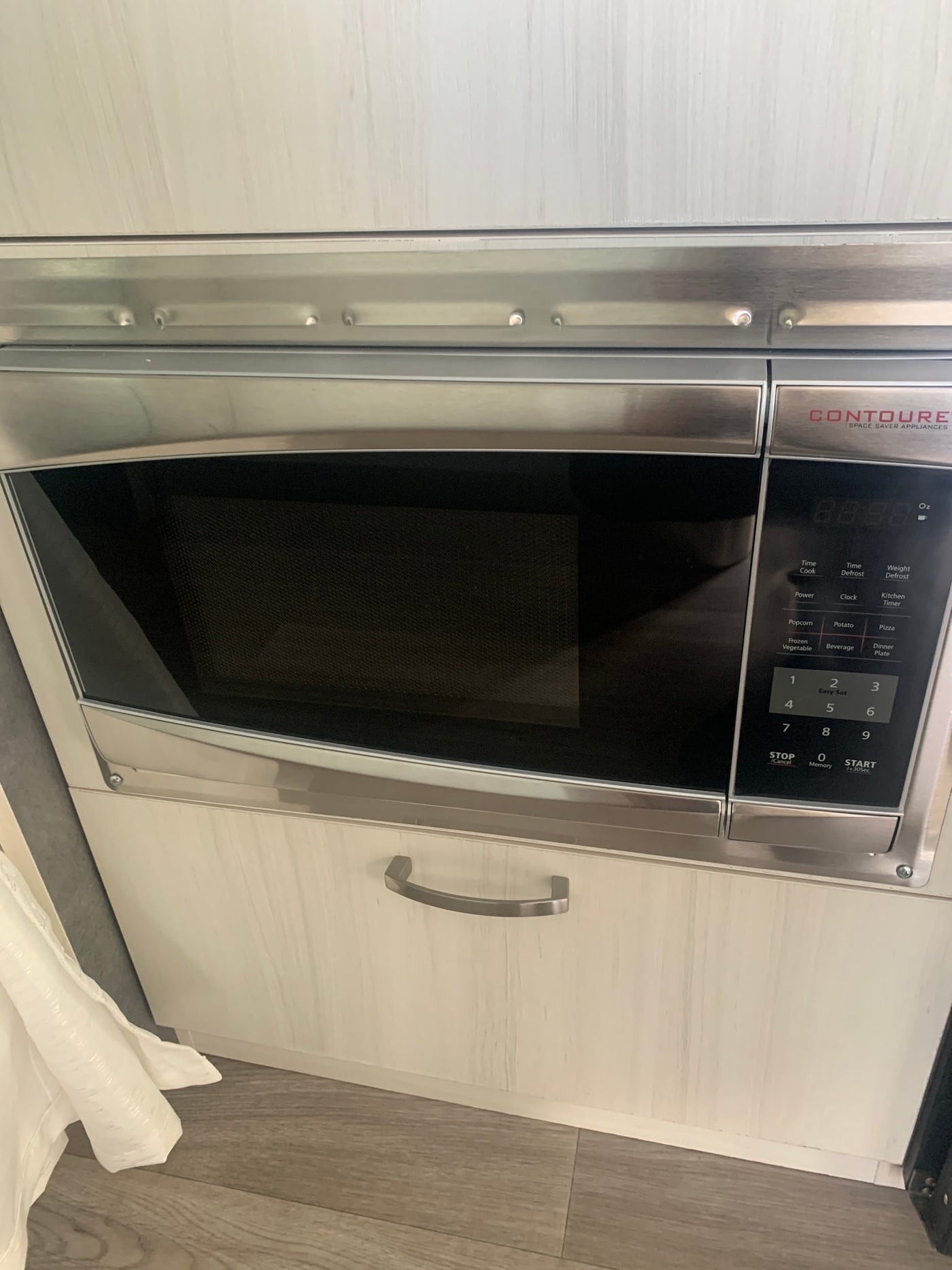 CONTOURE built-in microwave, a compact kitchen appliance, installed in an rv rental, with light wood cabinets and flooring. — photo 12