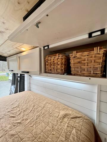 and compact kitchen/storage make for a great tiny home feel.|Cozy RV rental interior with a compact vanity