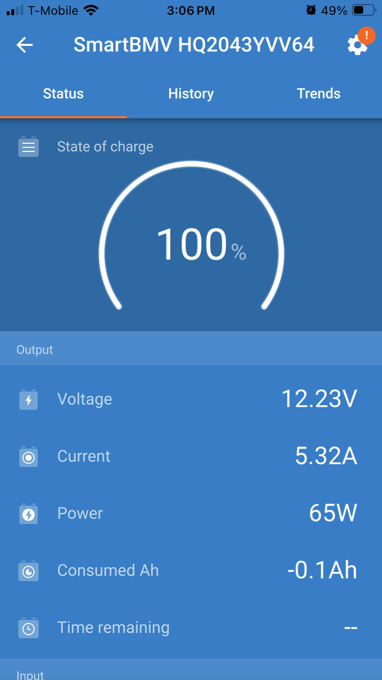 RV rental power display: 100% battery, 12.23V, 65W output. Battery monitor app for camper power management.