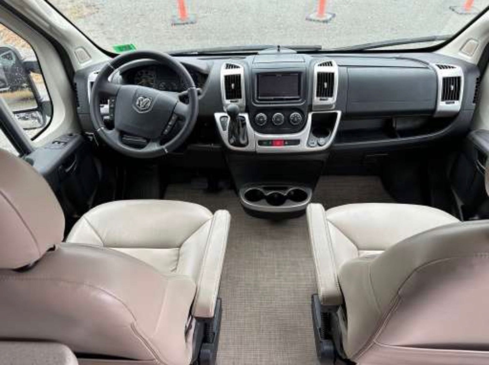 and compact fridge. Perfect for travel convenience.|This rv rental offers a comfortable interior with twin benches