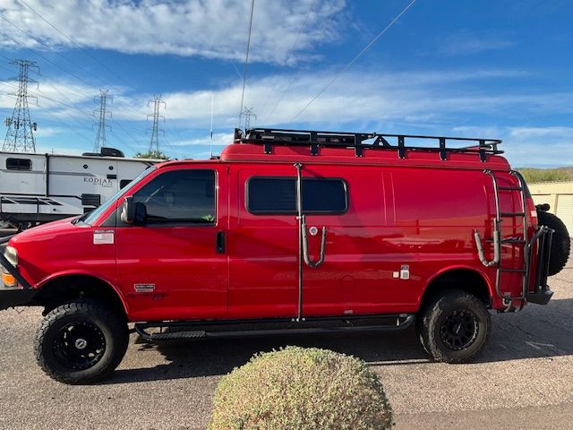 Explore in a red lifted off-road custom camper van