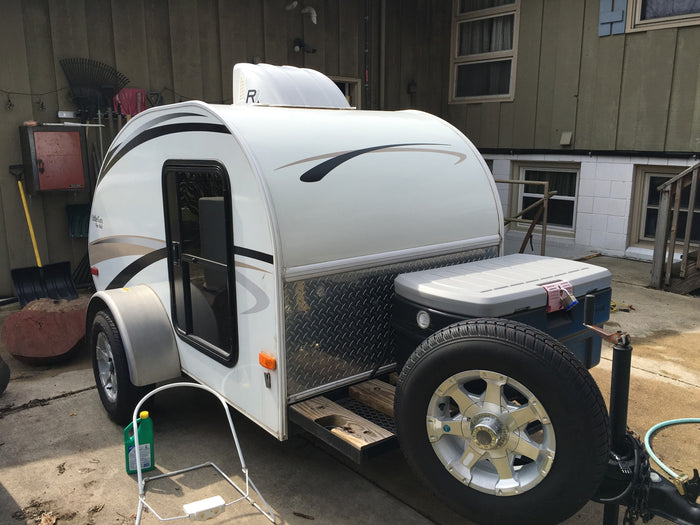 A white "Little Guy" Four Wide teardrop travel trailer, perfect for your next rv rental adventure or camping trip.