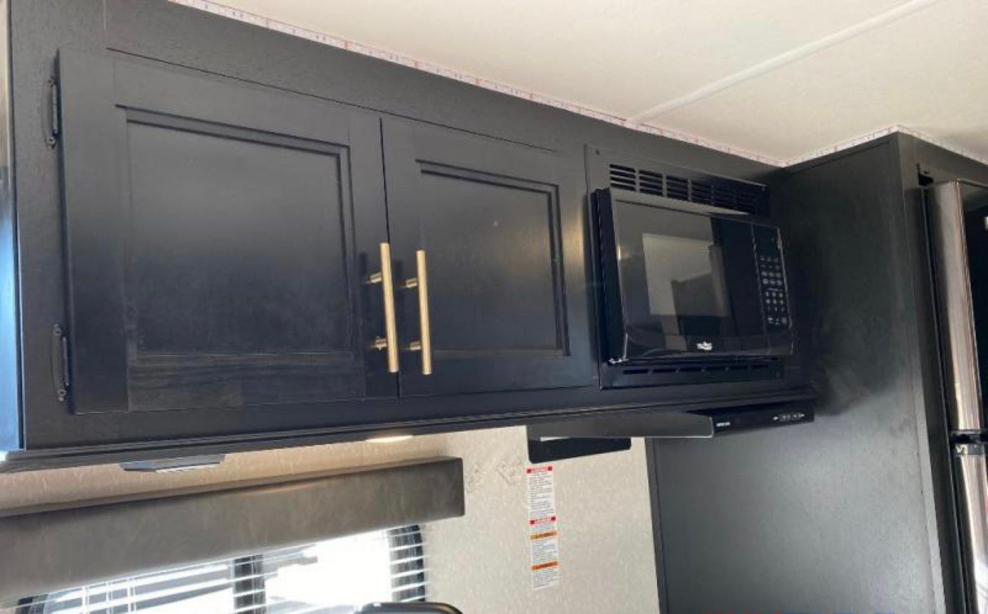 and blue LED awning lights.|This Wolf Pup RV rental is set up with steps and leveling jacks on a concrete pad