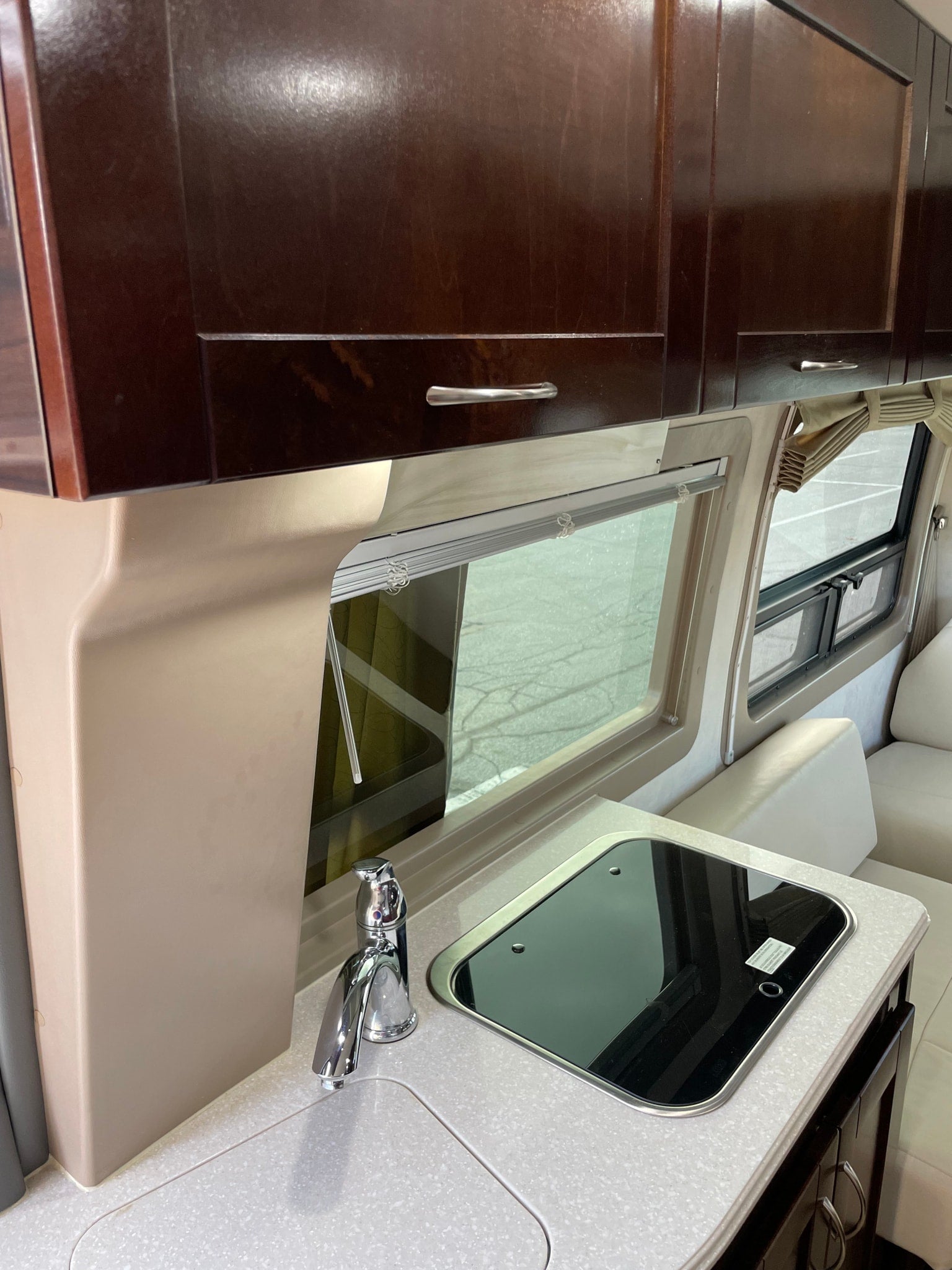 and rear sofa seating. Ideal for travel.|Inside a luxurious RV rental: sleek white seating