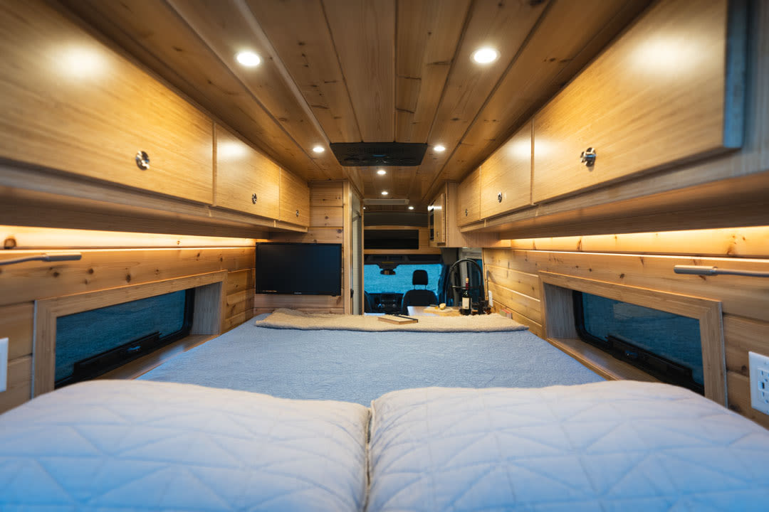 featuring a cozy wood-paneled living area with a bench