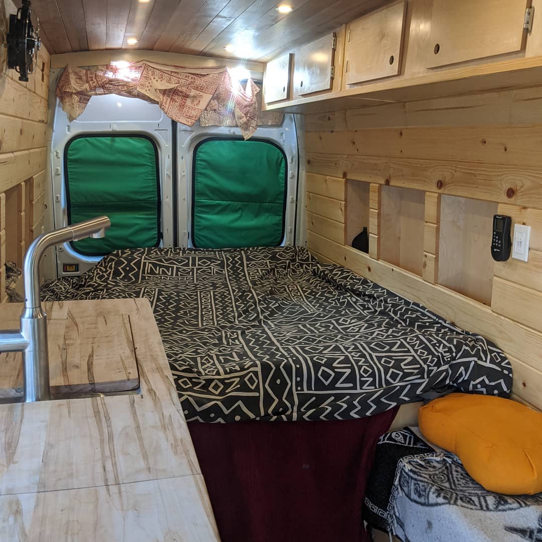 and ladder parked in a sunny desert landscape.|Cozy rv rental van with light snow — photo 5