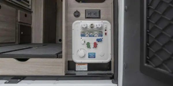 and mirror. Perfect for travel convenience.|RV rental camper interior: versatile bed