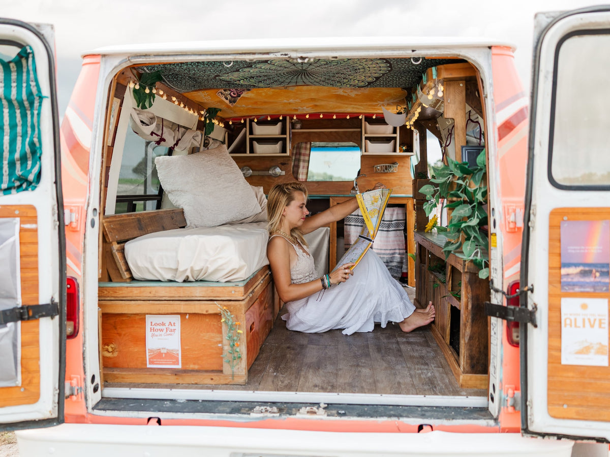 showcasing a cozy van life setup.|Woman working on a laptop in a cozy — photo 5