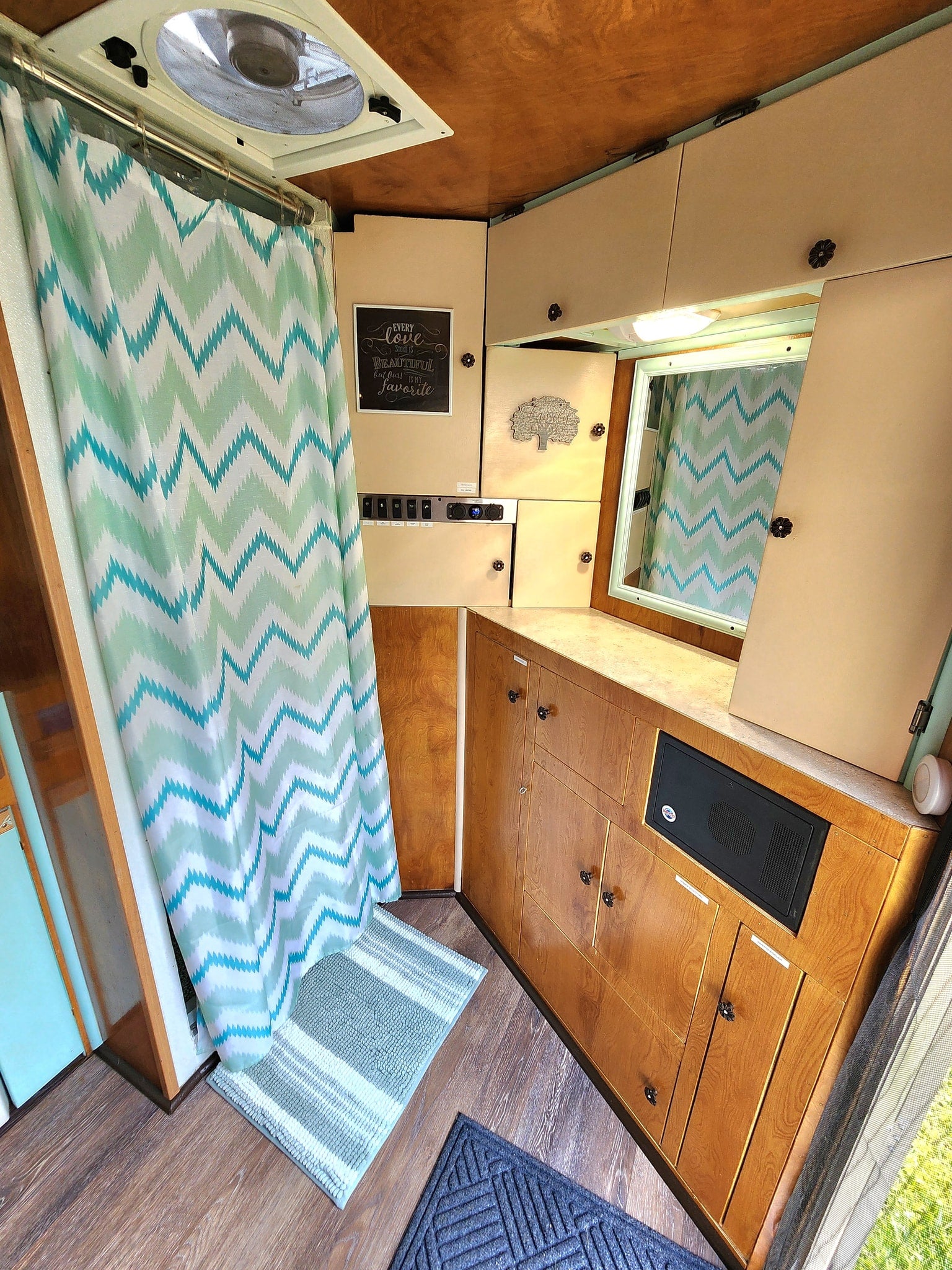 & outdoor gear.|Cozy RV rental interior featuring a bed