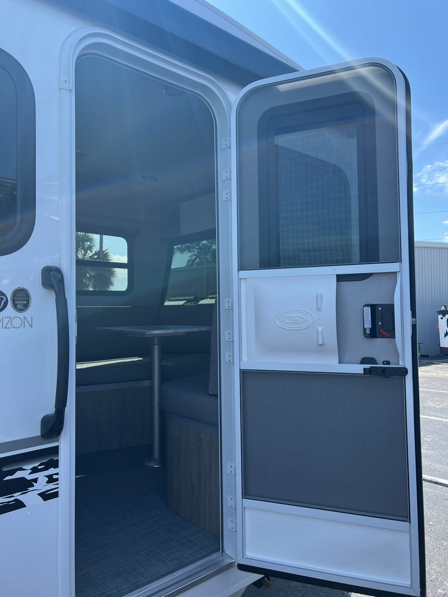 white and black travel trailer. This modern RV