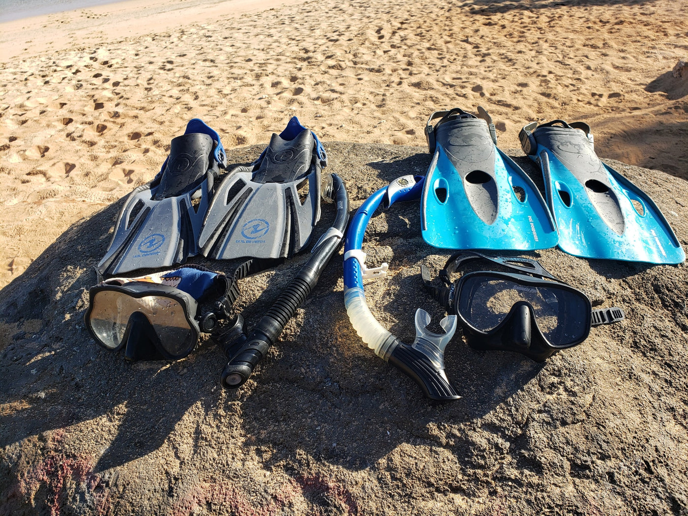 Snorkeling gear (fins, masks, snorkels) rests on a rock at the beach, ideal for an RV rental vacation. — photo 17