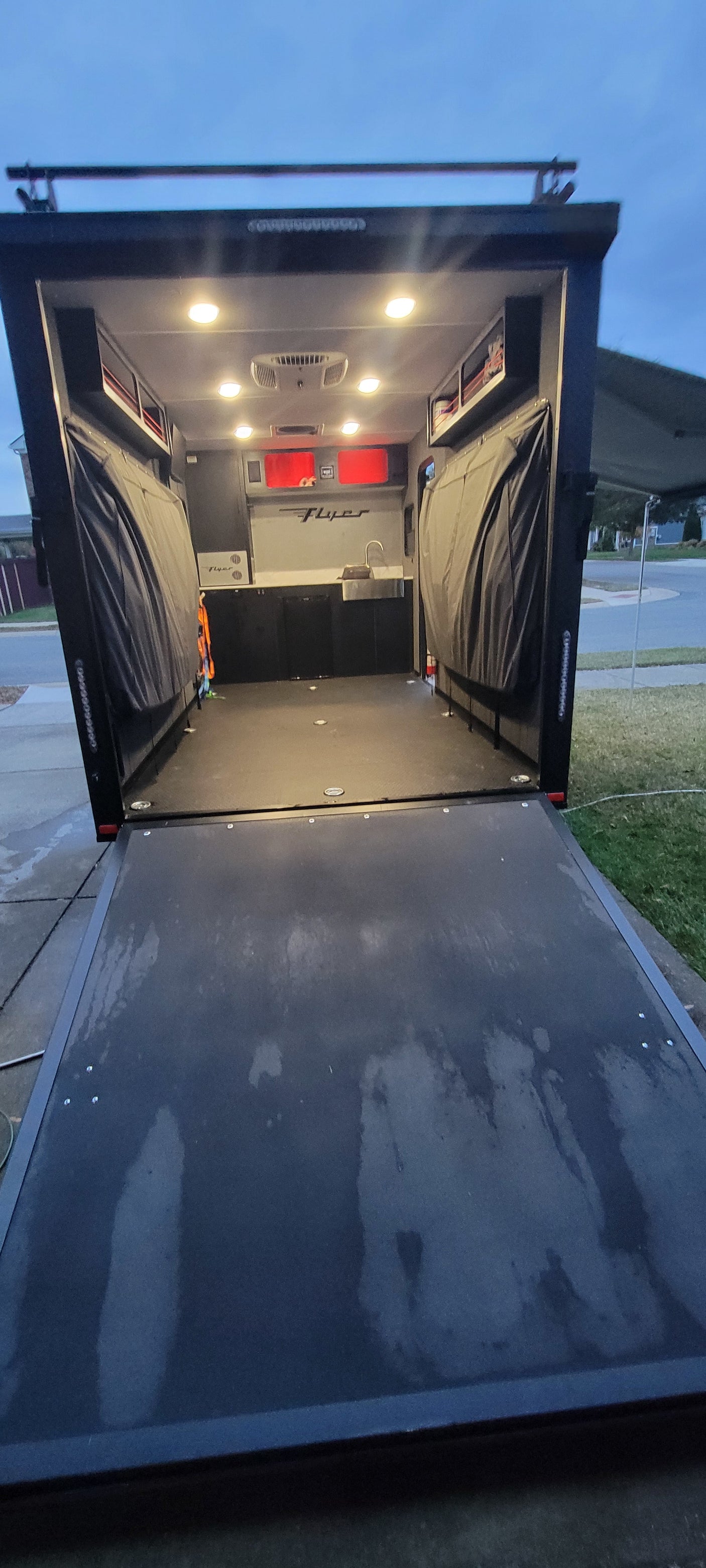 Experience adventure with this versatile utility trailer interior, ideal as an RV rental. Equipped with a kitchenette, lighting, and ramp.