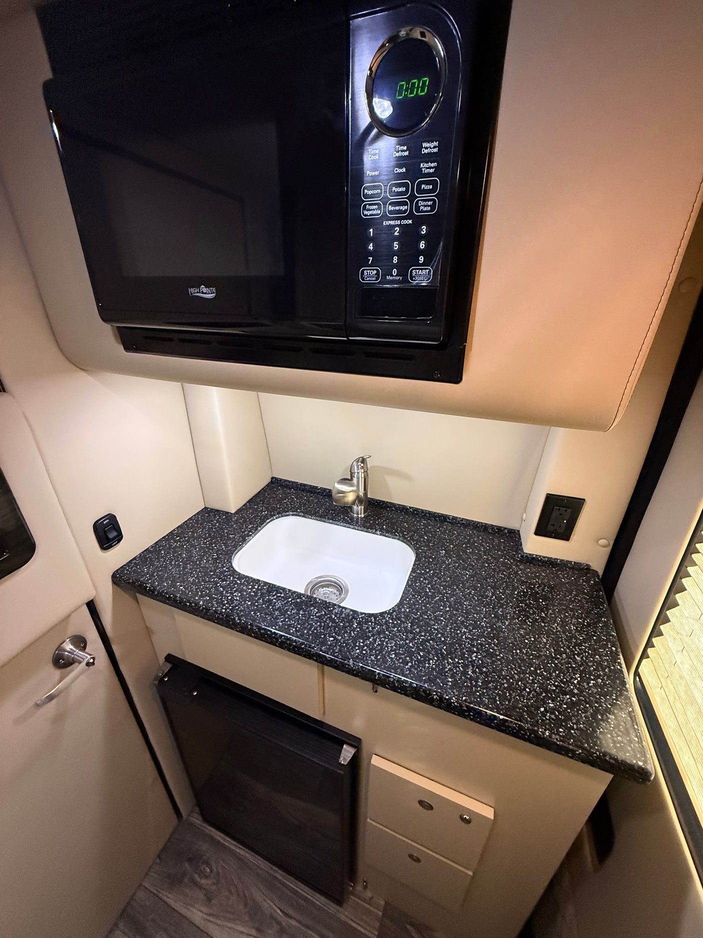 and blue ambient lighting.|Luxurious RV rental interior with plush cream-colored