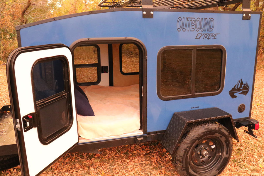 perfect for RV rental adventures. Enjoy fall camping & exploring the outdoors!|Explore outdoors with this blue teardrop camper RV rental. Its door is open