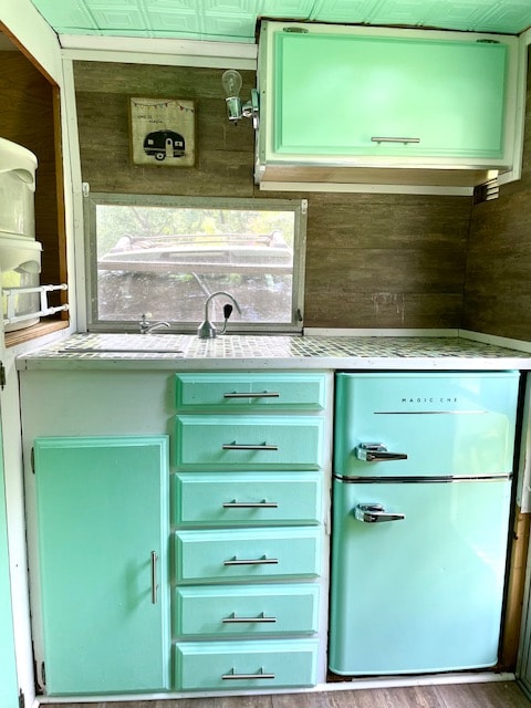 ideal for your next RV rental adventure. Retro camper fun!|Inside a retro-themed RV rental kitchen