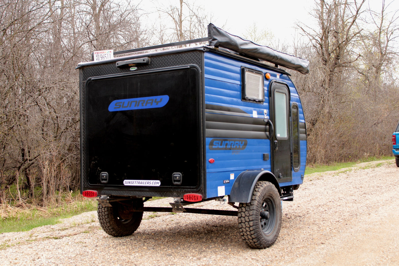 Blue Sunray teardrop camper for your next rv rental adventure. Features off-road tires & an awning. Perfect for camping!