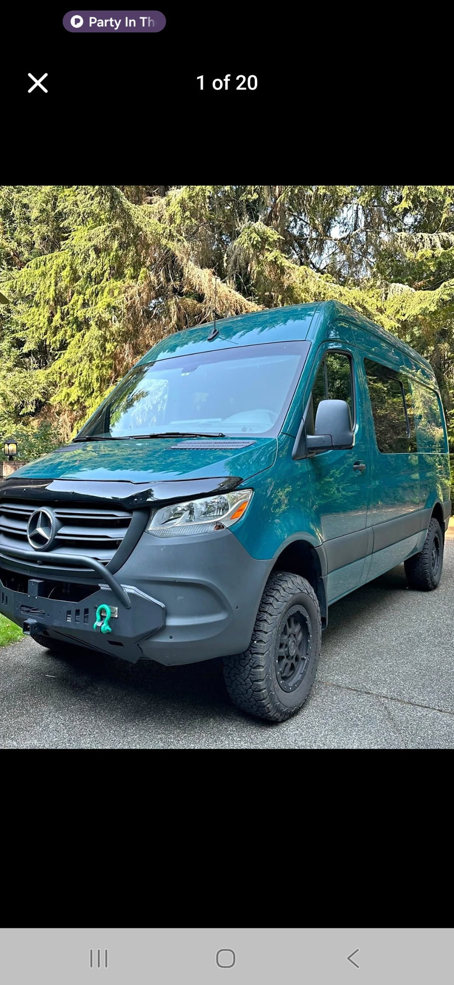 Explore with this teal Mercedes Sprinter van RV rental, equipped with rugged tires & custom bumper for adventure.