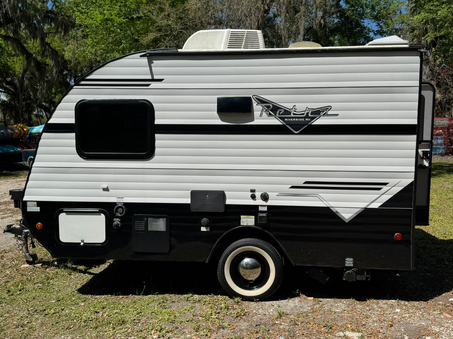 parked on grass.|Stylish Retro Riverside RV travel trailer for rv rental