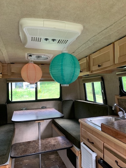 and a dining table.|Cozy RV rental interior showing a dinette